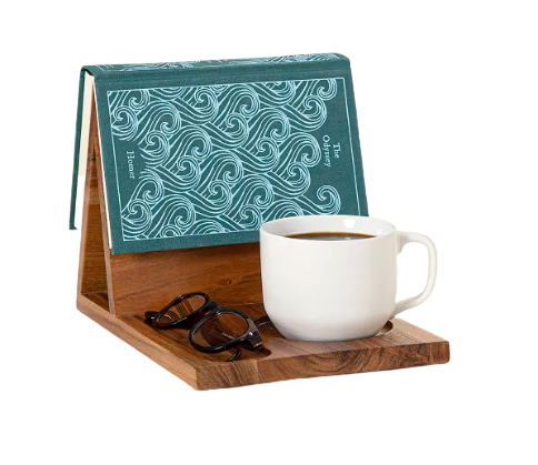 A portable wooden reading valet for your book nook that holds one book, one mug, and one pair of glasses